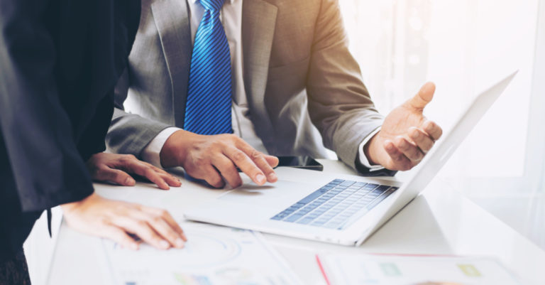 Types of exemption clauses in a contract represented by two people discussing a digital document