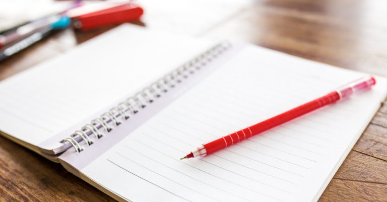 Redline contract red pen and paper