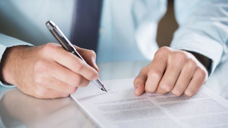 Procurement frontier man signing contract on paper