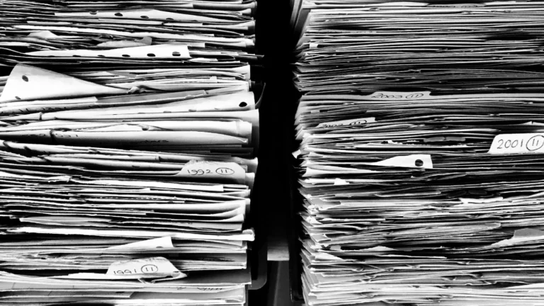 Two large stacks of paper documents