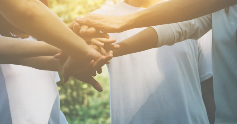 Empowering advocates represented by group of hands on top of each other